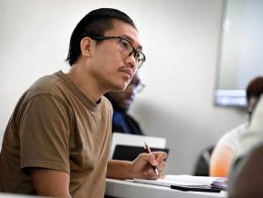 Lai Hnin takes notes in a class session